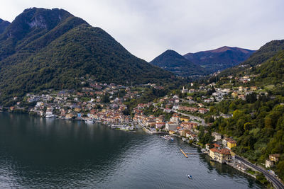 Scenic view of river by town against sky