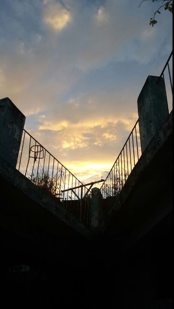 built structure, architecture, low angle view, sky, sunset, bridge - man made structure, connection, silhouette, railing, cloud - sky, orange color, building exterior, bridge, engineering, transportation, cloud, outdoors, no people, metal, sunlight