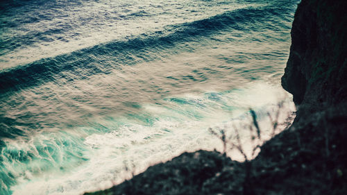 High angle view of waves rushing towards shore