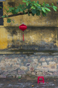 Red lantern hanging against wall