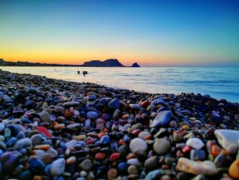 Scenic view of sea against clear sky at sunset