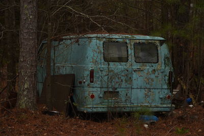 Old abandoned car on field