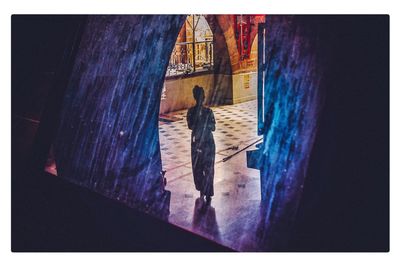 Rear view of man and woman standing at beach