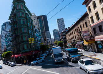 View of city street and buildings against sky