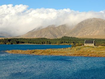 Scenic view of lake and mountains against sky