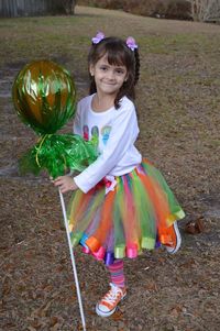 Portrait of cute smiling girl wearing halloween costume on field