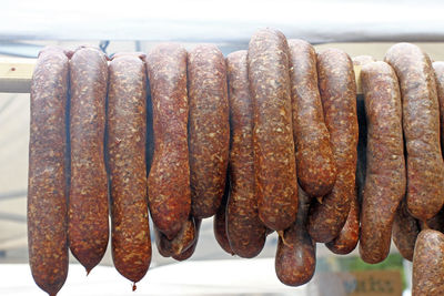 Close-up of meat hanging on barbecue grill