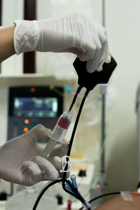 Cropped hands of doctor testing patient blood in hospital