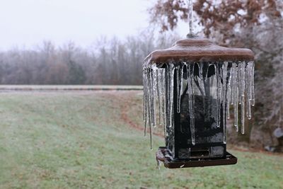 Close-up of old water wheel on field