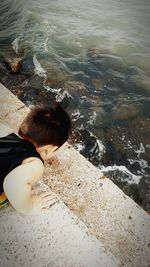 High angle view of girl standing in sea
