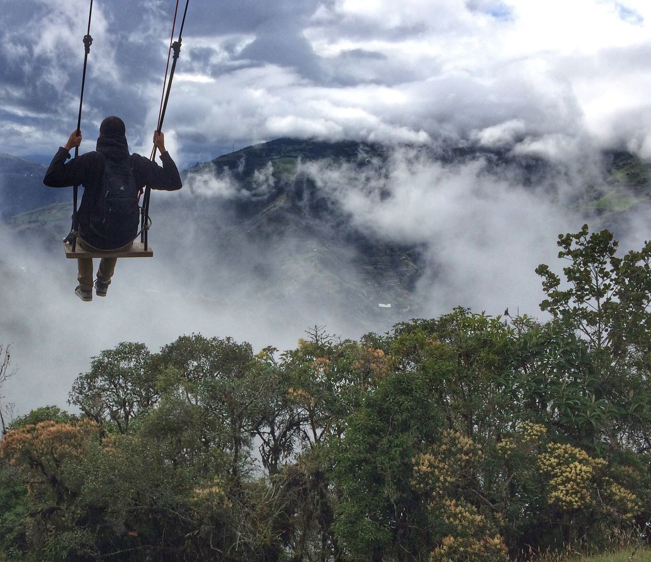 LOW ANGLE VIEW OF PERSON ON SWING