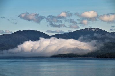 Scenic view of lake and mountains against sky