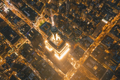 Breathtaking aerial view of the empire state building at night in manhattan, new york city at night with glowing city lights