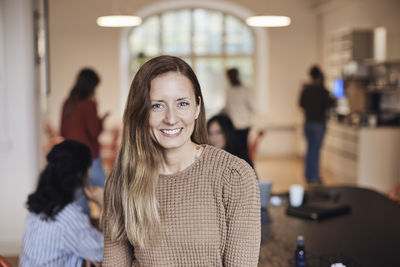 Portrait of smiling female entrepreneur at coworking office