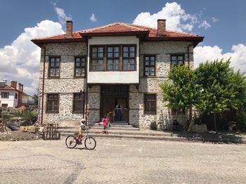 Bicycle outside house against building