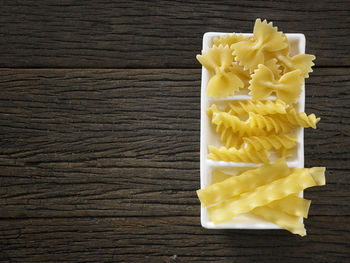 Close-up of colorful fusilli pasta in container on table