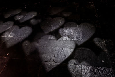 High angle view of shadow on stone wall