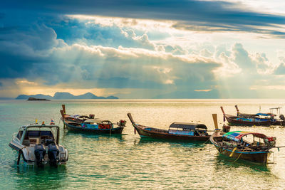 Boats moored in sea against sky