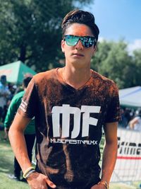 Portrait of young man wearing sunglasses standing outdoors