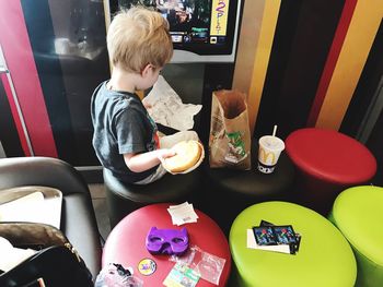 Boy sitting on table at home