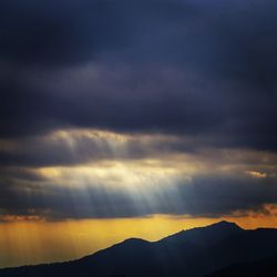 Scenic view of mountains against cloudy sky