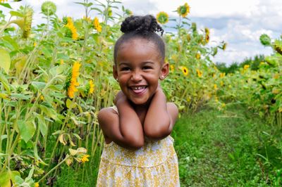 Portrait of cute girl smiling on field