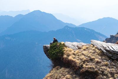 Man sitting on cliff