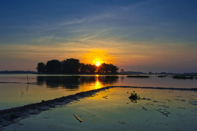 Scenic view of lake against sky during sunset