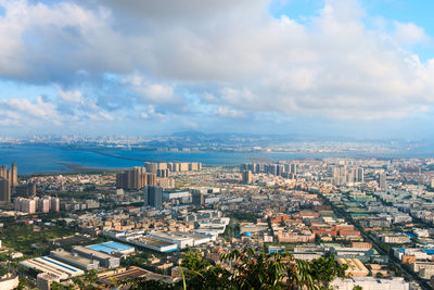 Cityscape against cloudy sky