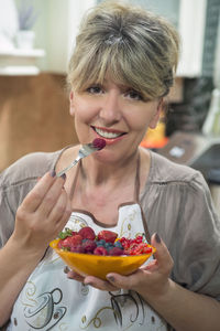 Portrait of woman holding ice cream