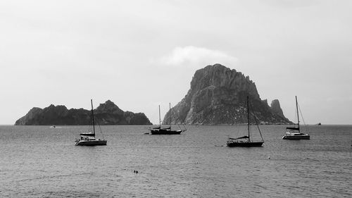 Sailboats on sea against sky