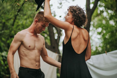 Midsection of man standing against trees