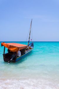 Boat on sea against blue sky