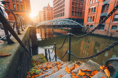 Bridge over canal amidst buildings in city