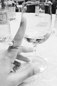 Close-up of hand holding beer glass on table