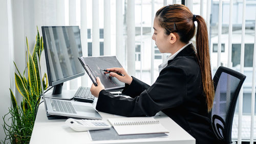 Businesswoman using laptop at office