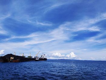 Scenic view of sea against blue sky