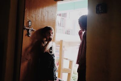 Man and woman standing by door