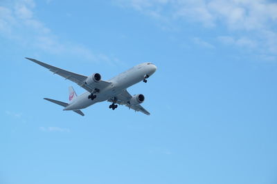 Low angle view of airplane flying in sky