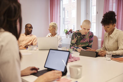 Coworkers sitting at business meeting in meeting room