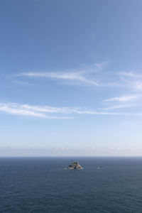 Boat sailing on sea against sky