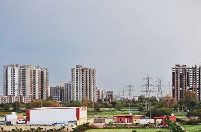 Buildings in city against clear sky