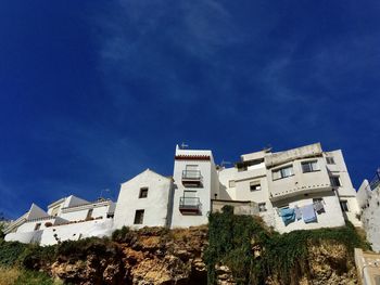 Low angle view of buildings against blue sky