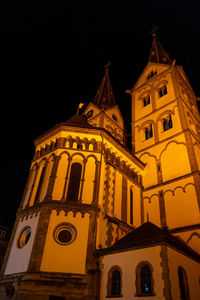 Low angle view of illuminated building against sky at night