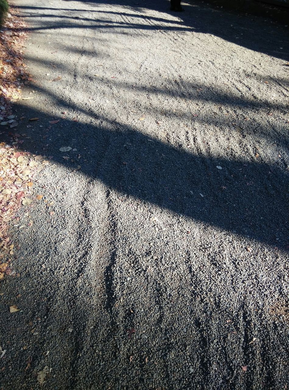 sand, shadow, sunlight, beach, tranquility, full frame, high angle view, textured, backgrounds, nature, pattern, day, outdoors, tranquil scene, footprint, landscape, no people, beauty in nature, shore, natural pattern