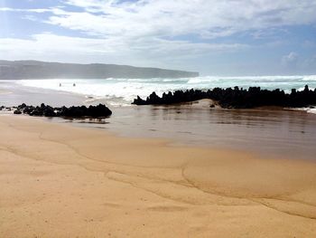 Idyllic shot of sea and beach against sky