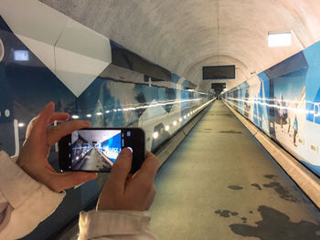 Close-up of man photographing on mobile phone