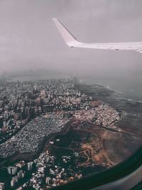 Aerial view of buildings in city against sky