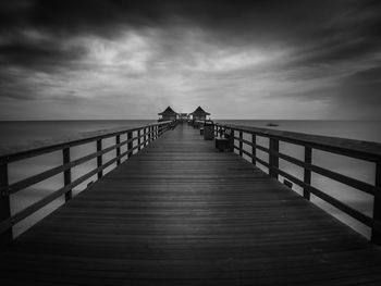 Pier over sea against sky