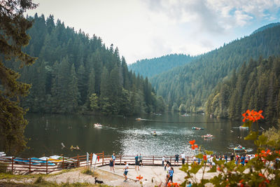 Scenic view of lake by trees against sky